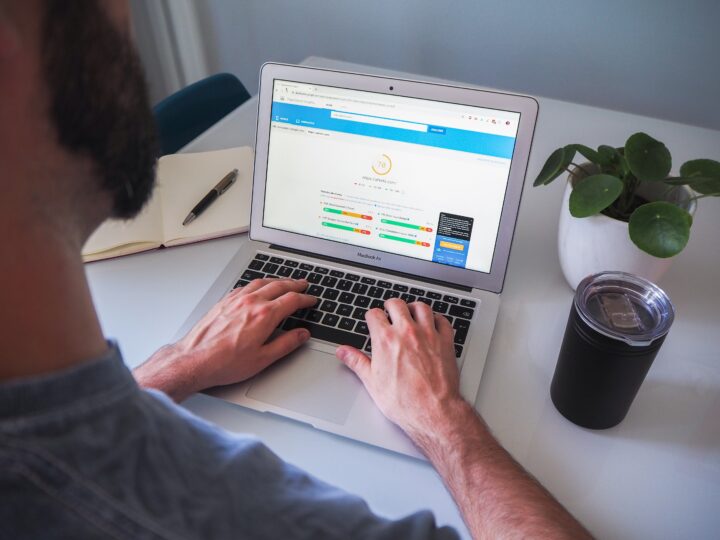 Bearded man looking at SEO analysis on a laptop
